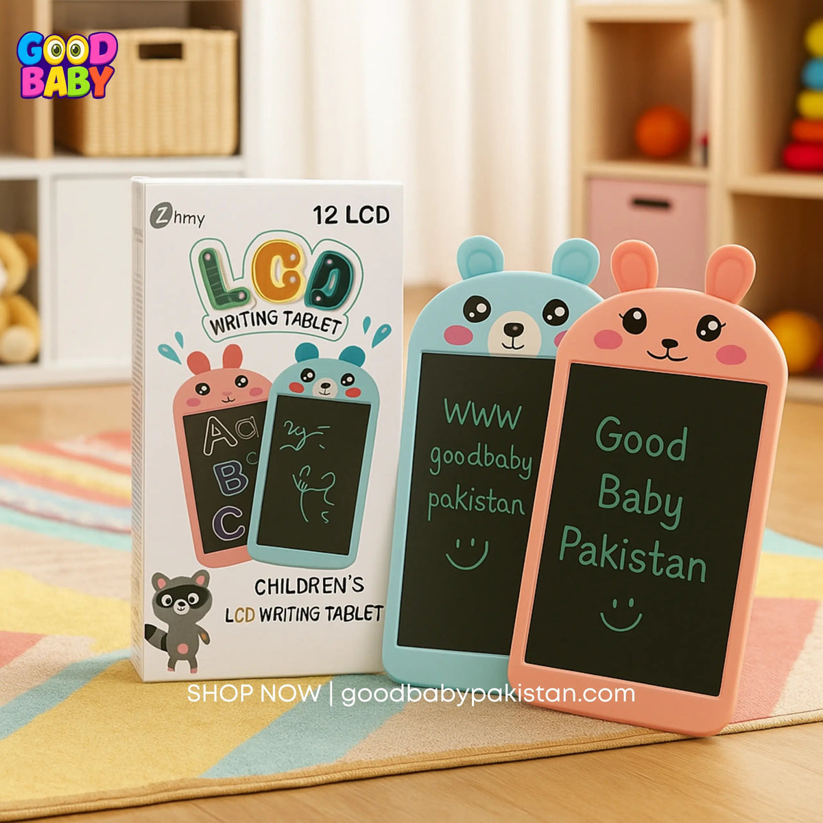 Two children's LCD writing tablets with a box labeled 'Good Baby' on a colorful rug.