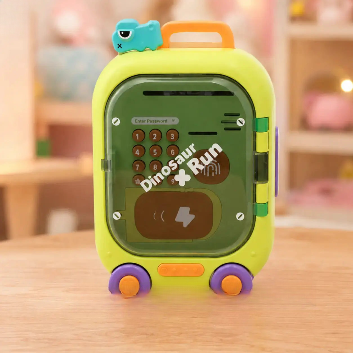 Colorful toy with a keypad and 'Dinosaur Run' text on a wooden surface, branded 'Good Baby'.