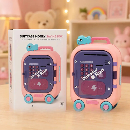 Pink suitcase-shaped money saving box with dinosaur design next to its packaging on a wooden surface
