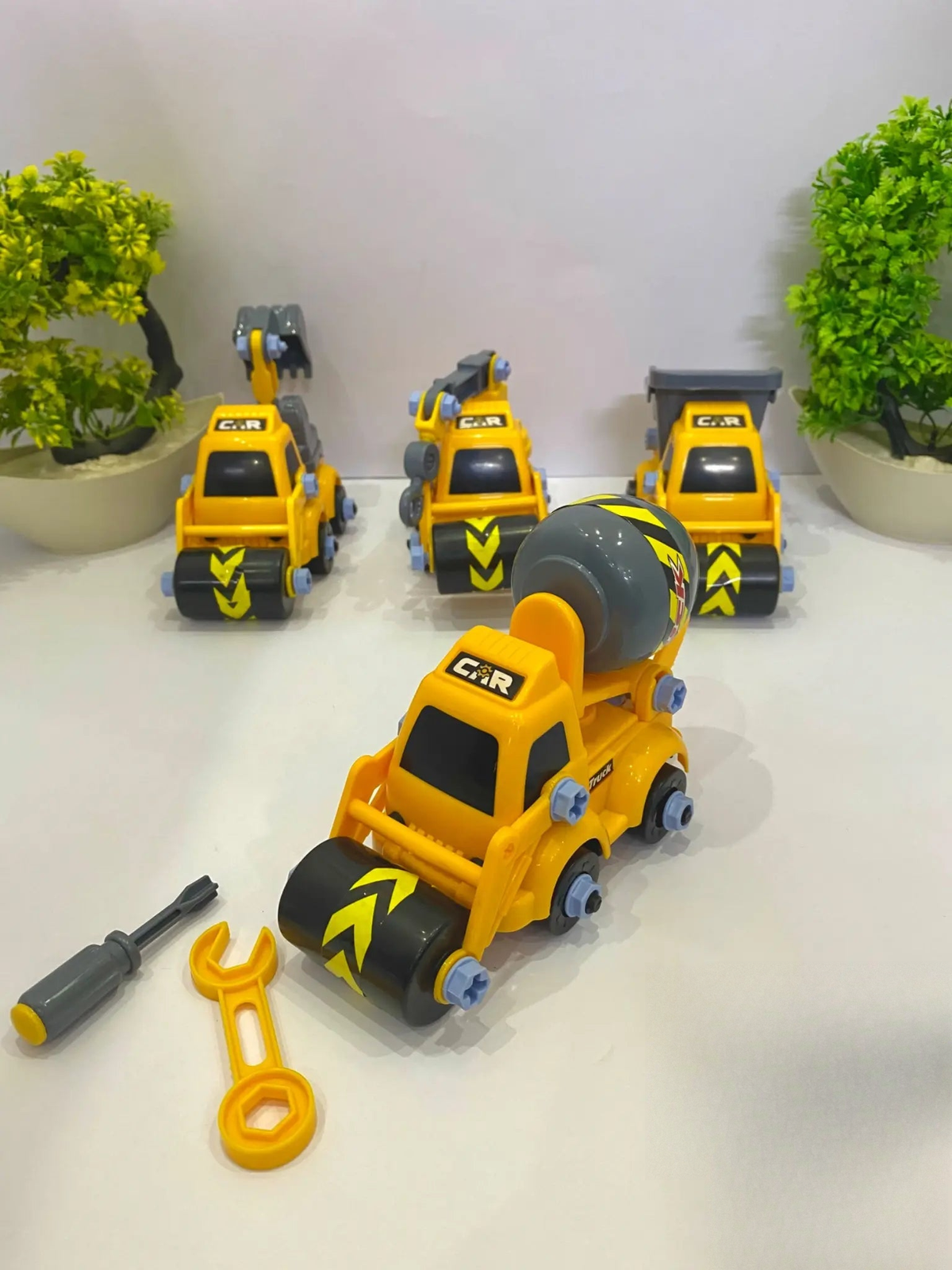 Children assembling mini construction trucks – STEM building toy