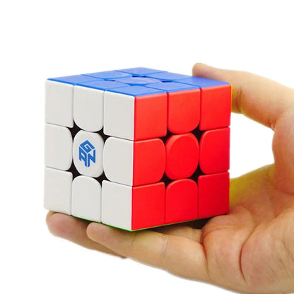 Rubik's cube with red, white, and blue sides held in a hand on a white background.