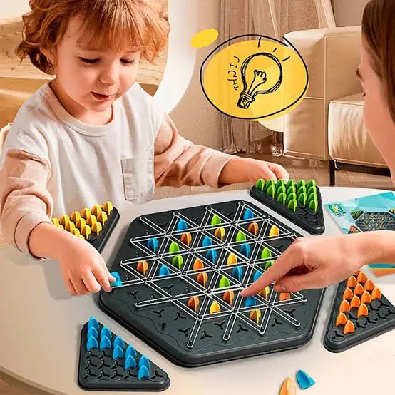 Two children playing with a colorful puzzle game on a table.