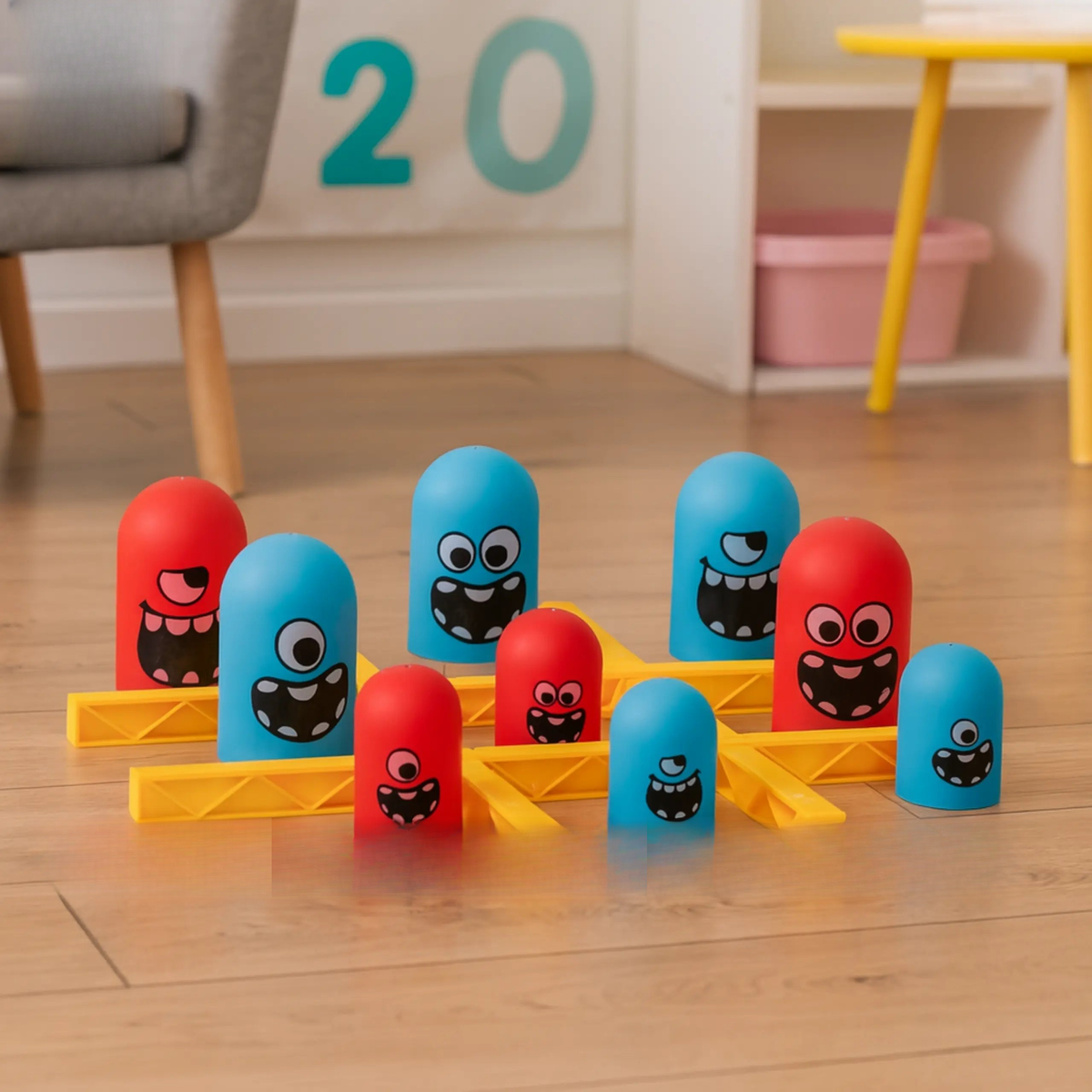 Colorful toy bowling set with red and blue pins on a wooden floor, featuring 'Good Baby' branding.