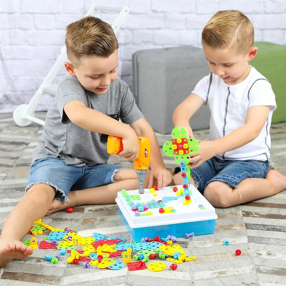 Two children playing with a colorful building block set on a wooden floor.